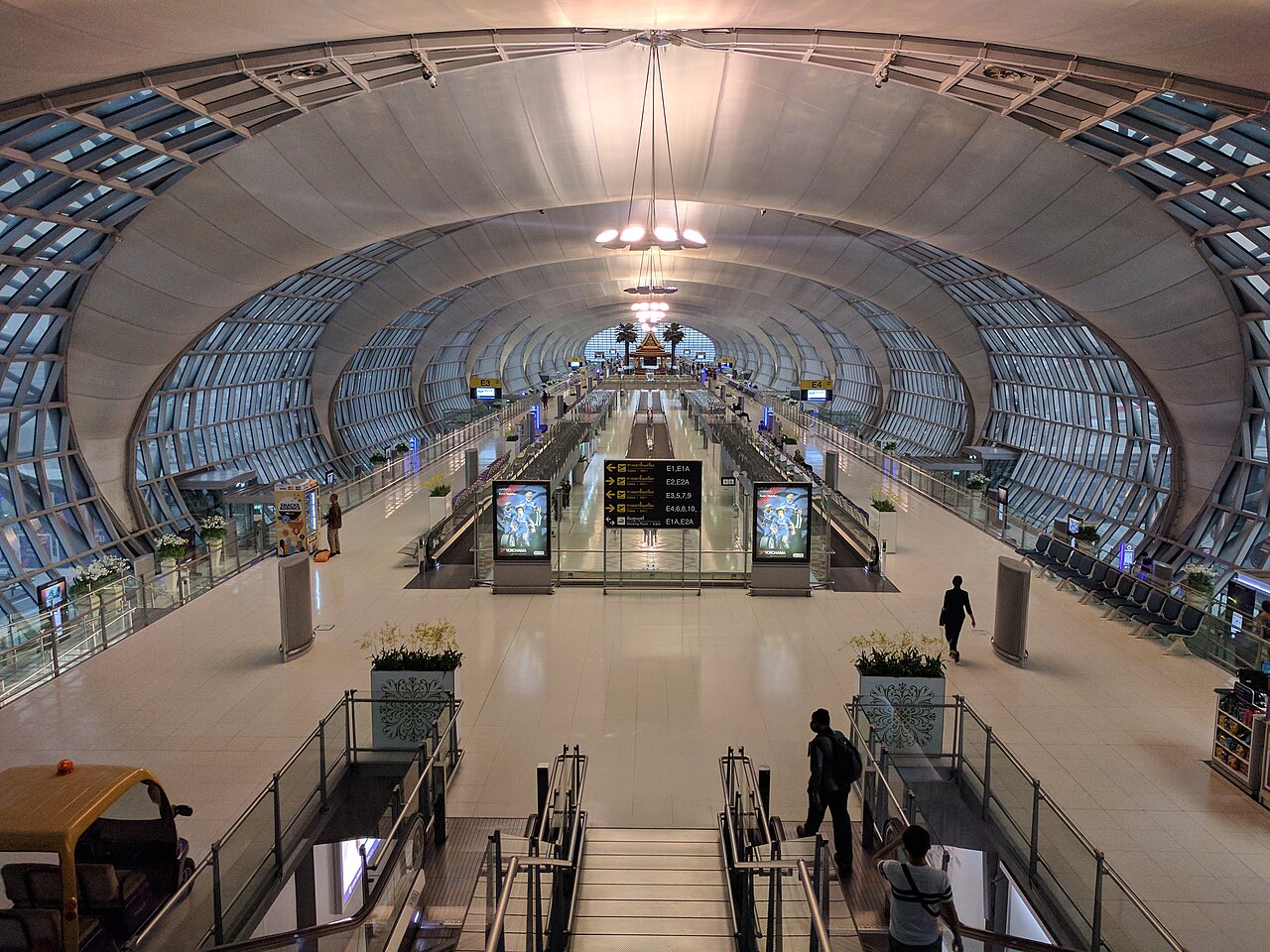 Bright, quiet international terminal concourse at dusk